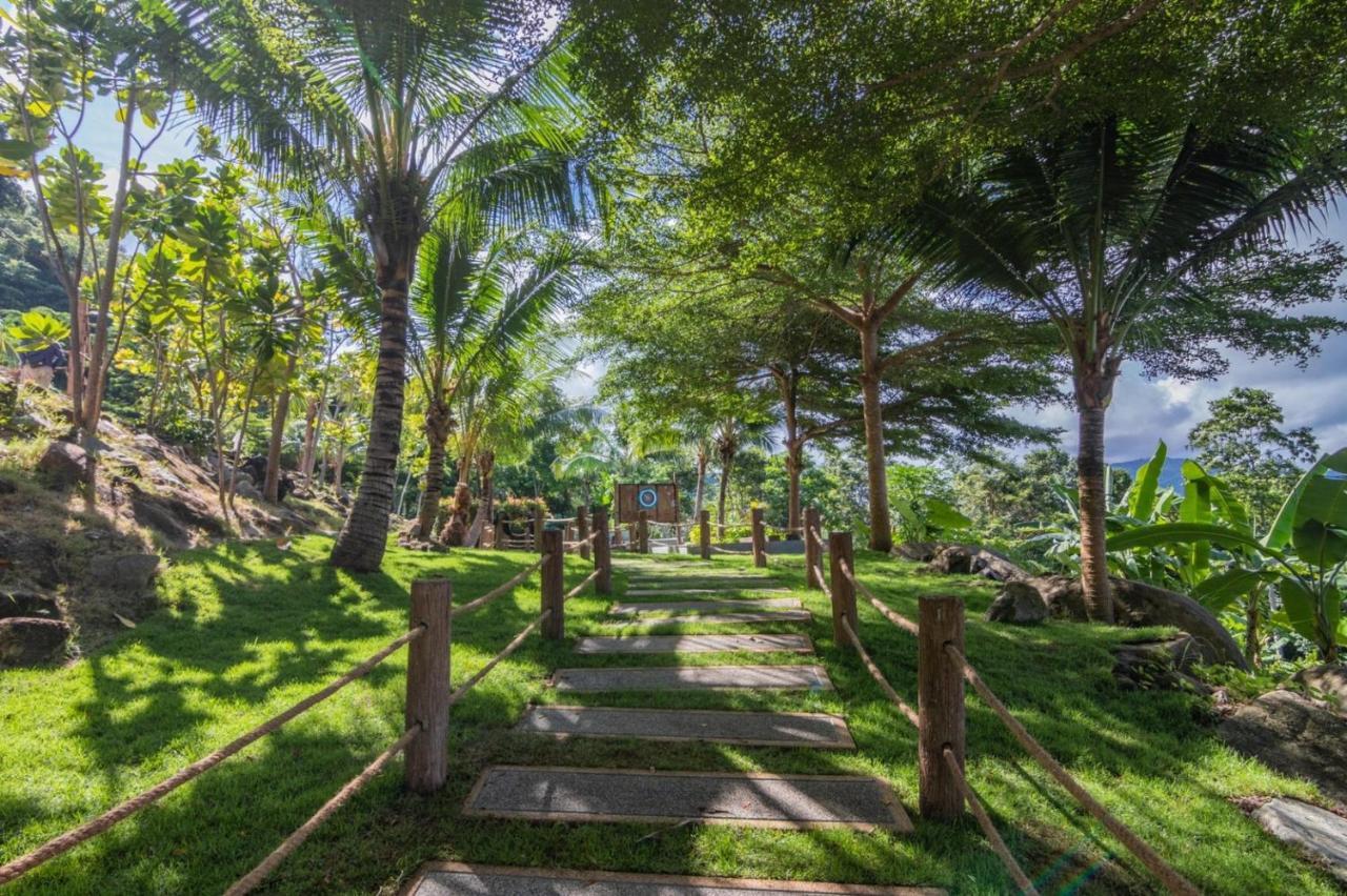 Kalima Resort And Spa Patong Kültér fotó The path to the temple